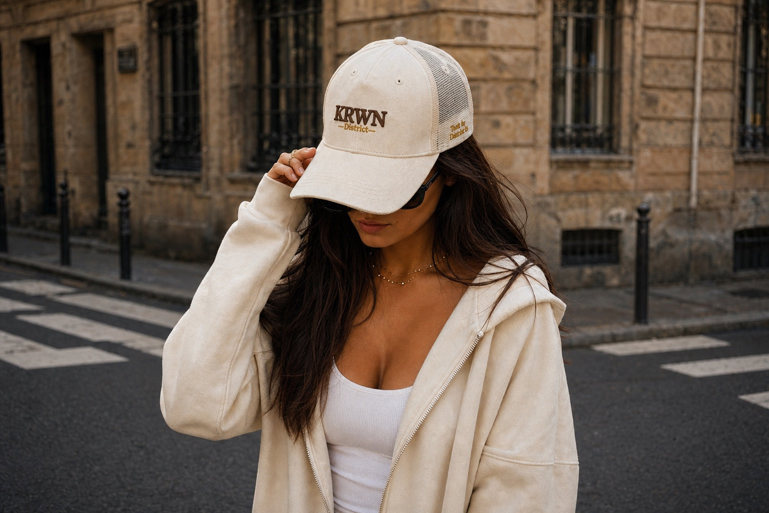 Woman wearing a cream KRWN District premium cotton canvas baseball cap on a European street