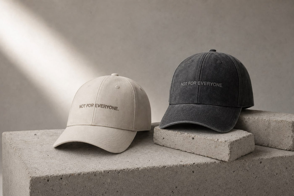 KRWN District The Code baseball caps in Stone Off White and Washed Black, editorial studio shot