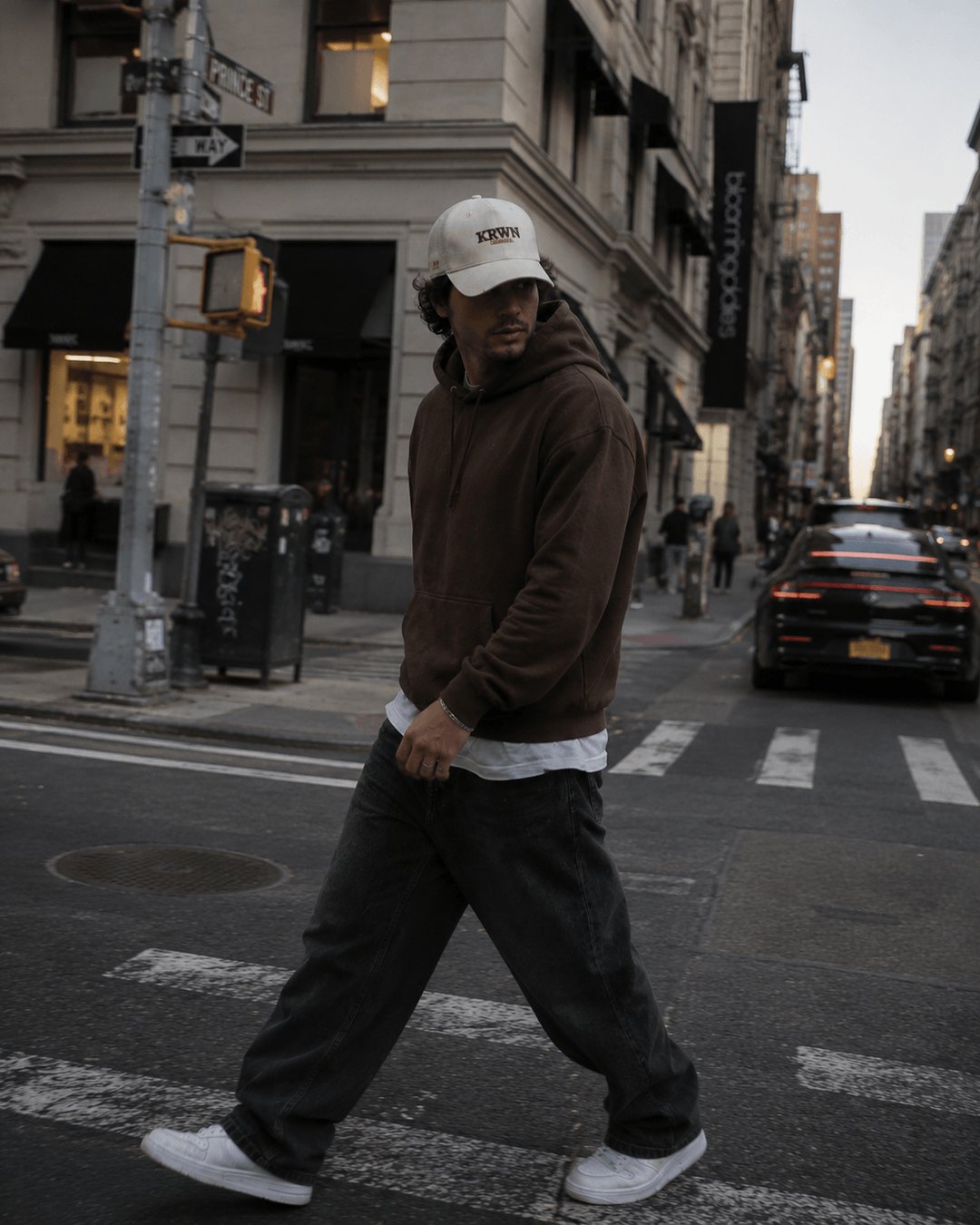 Man wearing cream KRWN District baseball cap in SoHo New York — premium streetwear cap