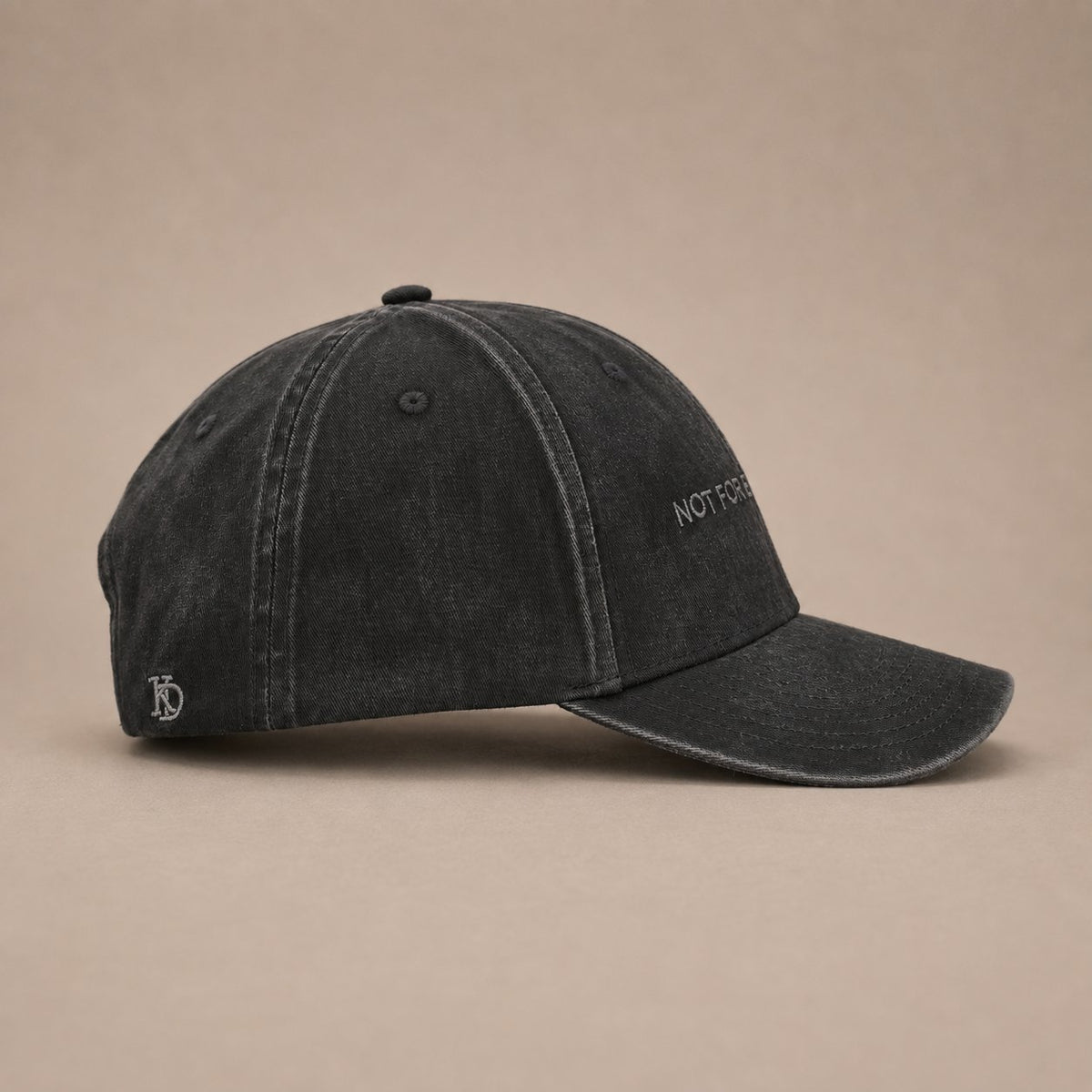KRWN District The Code — Washed Black, side view with embroidered KD emblem (AI-generated)