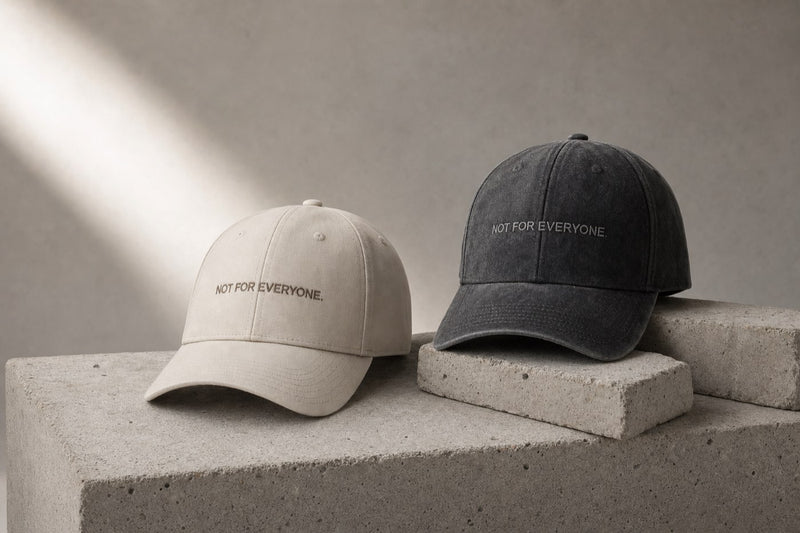 KRWN District The Code baseball caps in Stone Off White and Washed Black, editorial studio shot
