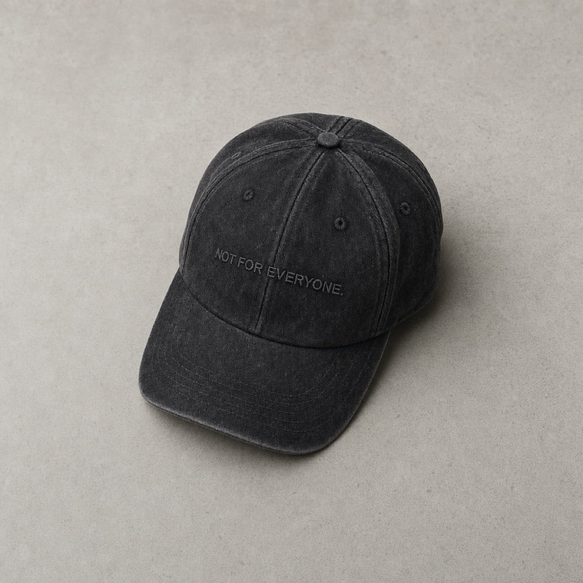 KRWN District The Code — Washed Black flat-lay on concrete