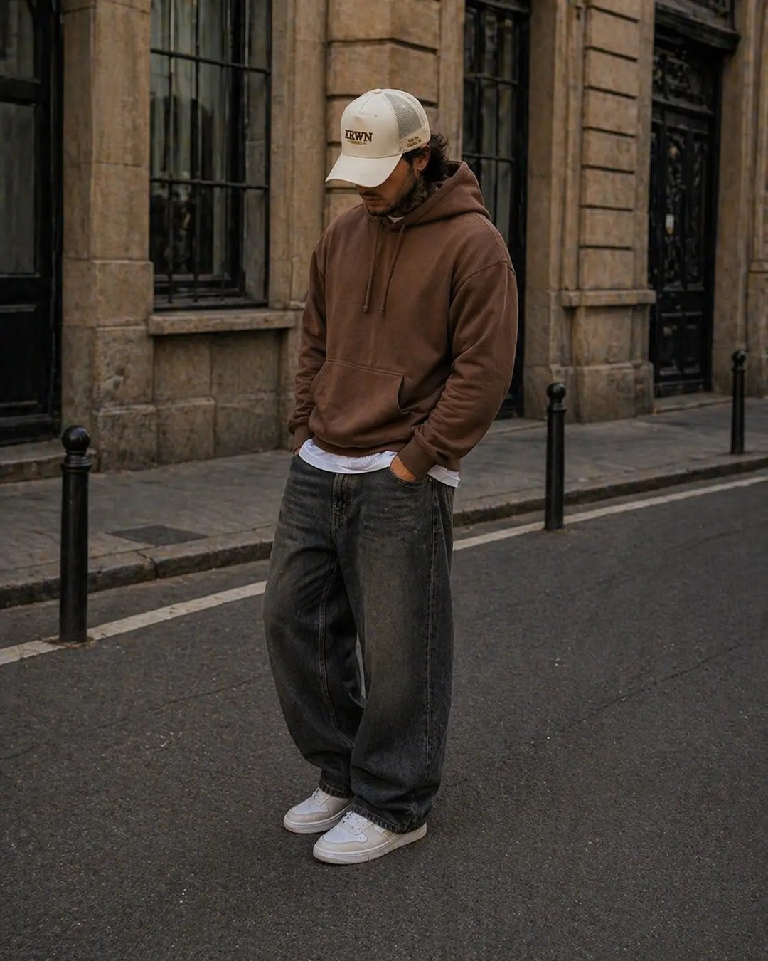 Man wearing cream KRWN District trucker cap on a European street — premium streetwear cap