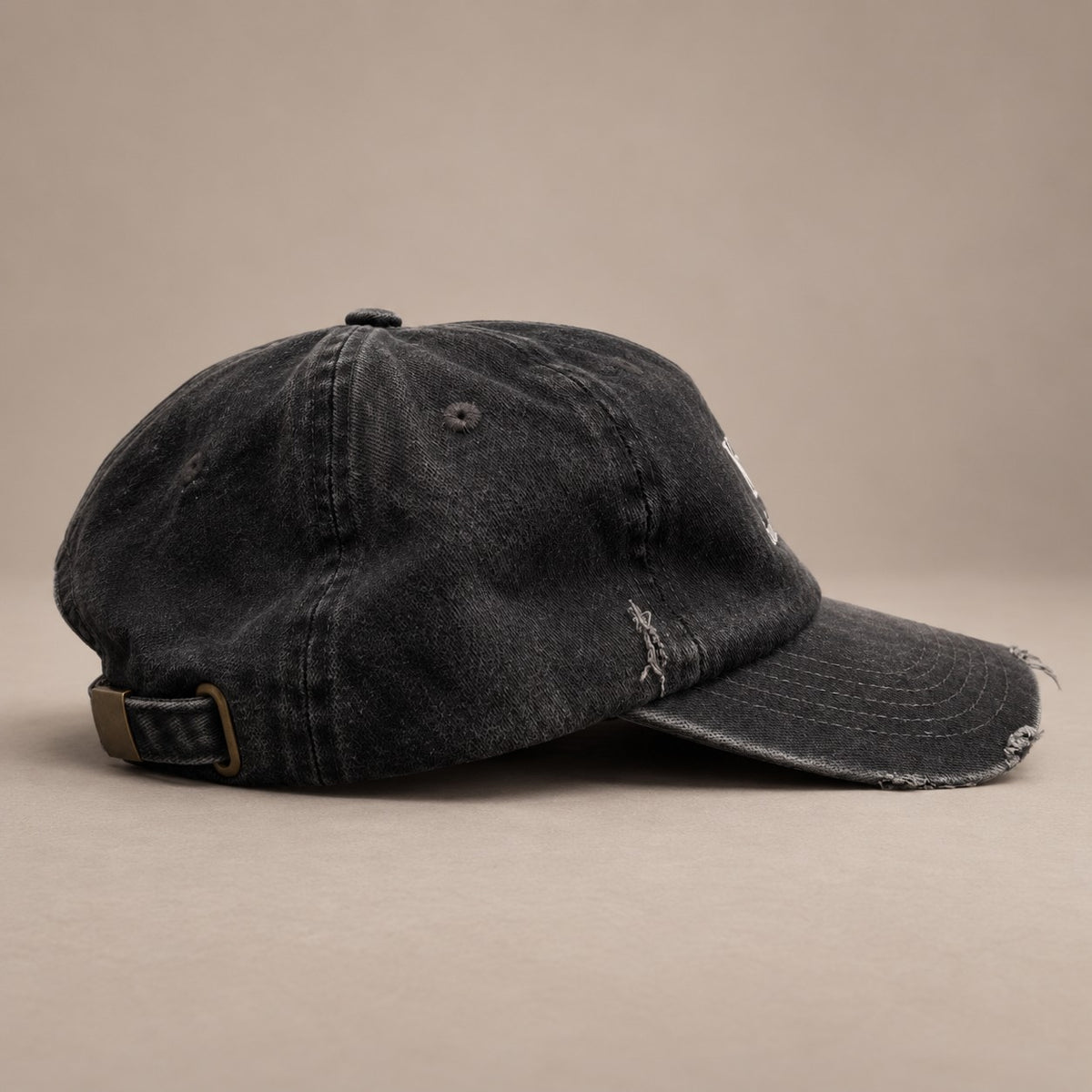 KRWN DISTRICT The Culture Washed Black — low-profile vintage 5-panel cap, side view with distressed visor (AI-generated)
