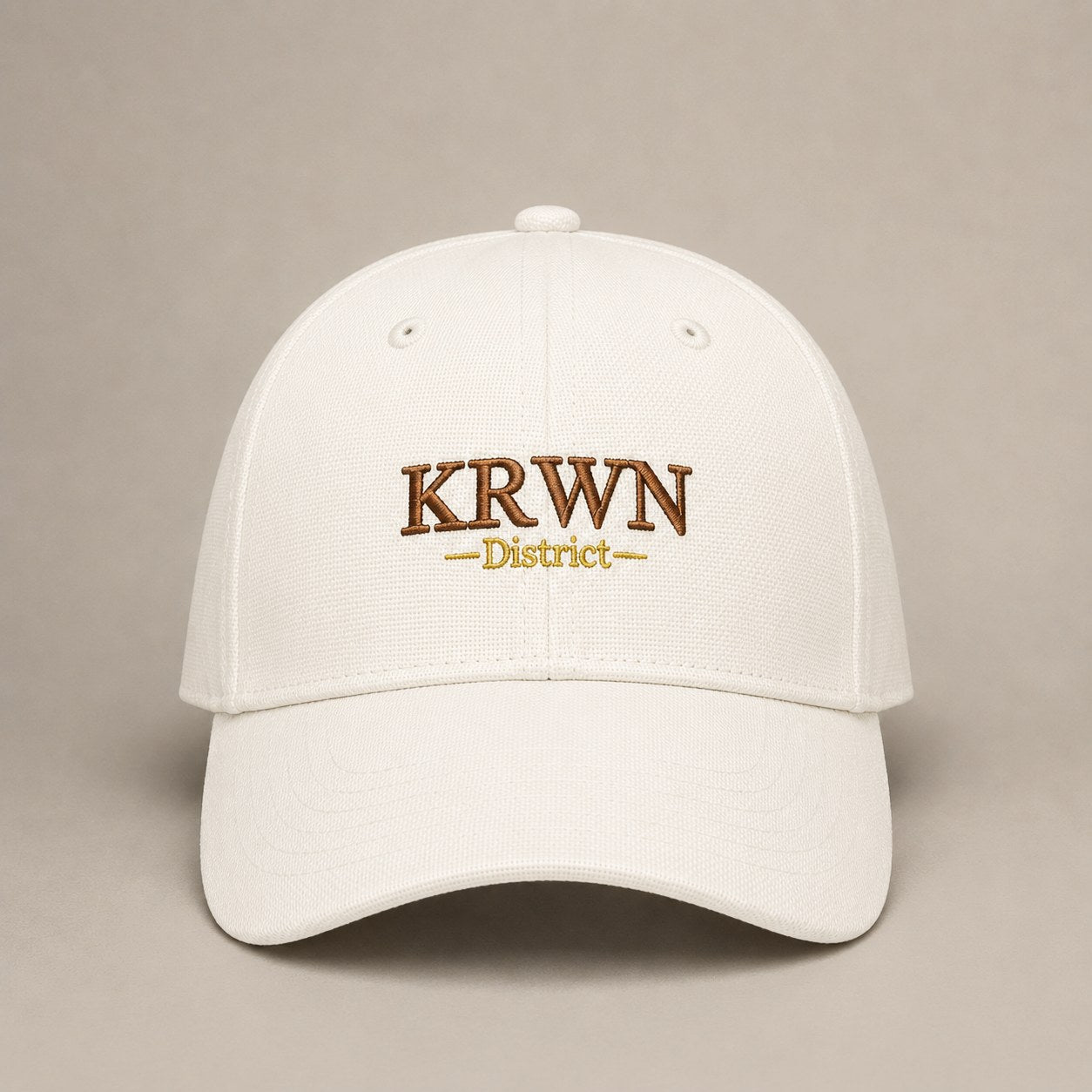 KRWN District Baseball Cap — Rule the District '26, front view with KRWN District embroidery on cream cotton canvas
