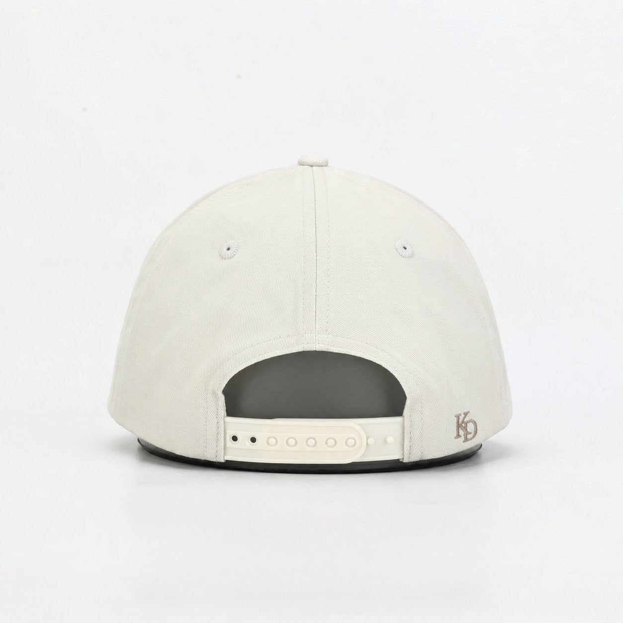 Stone Off White cap back view with embroidered KD monogram and adjustable closure #Color_Stone Off White