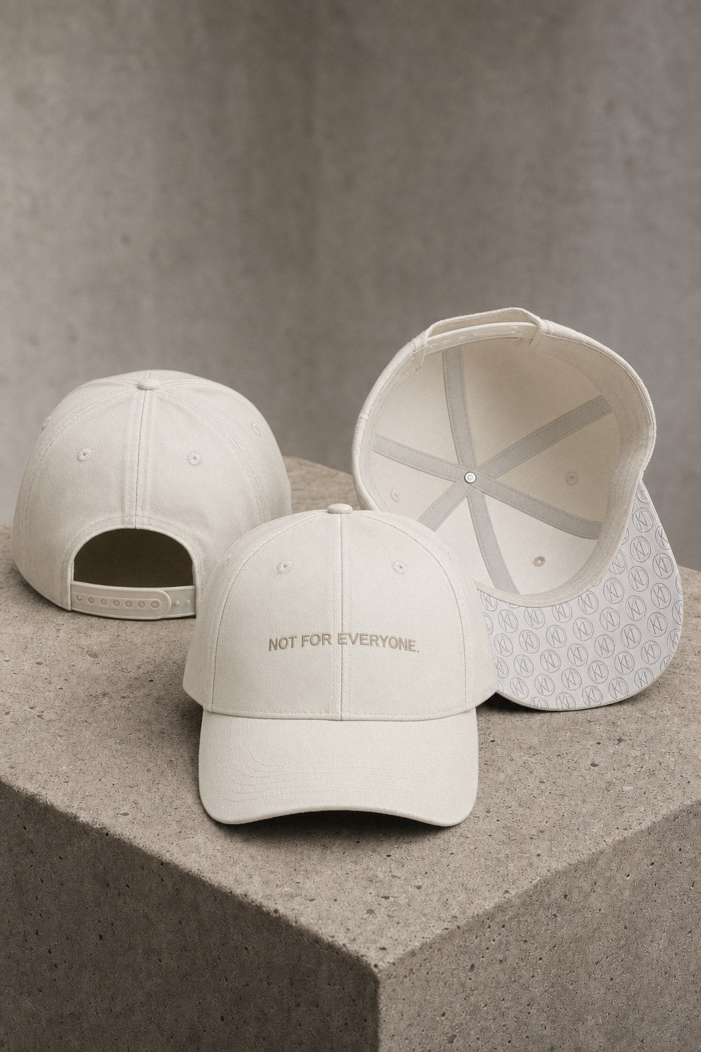 KRWN District The Code baseball caps in Stone Off White on concrete — back, front and under-brim monogram detail #Color_Stone Off White