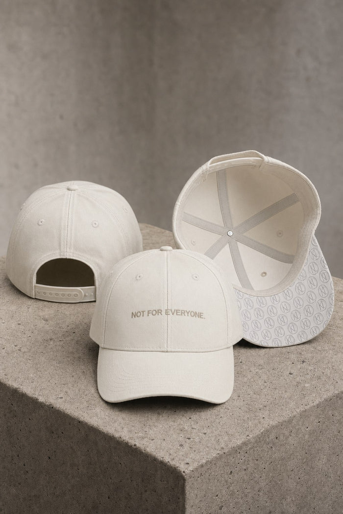 KRWN District The Code baseball caps in Stone Off White on concrete — back, front and under-brim monogram detail #Color_Stone Off White